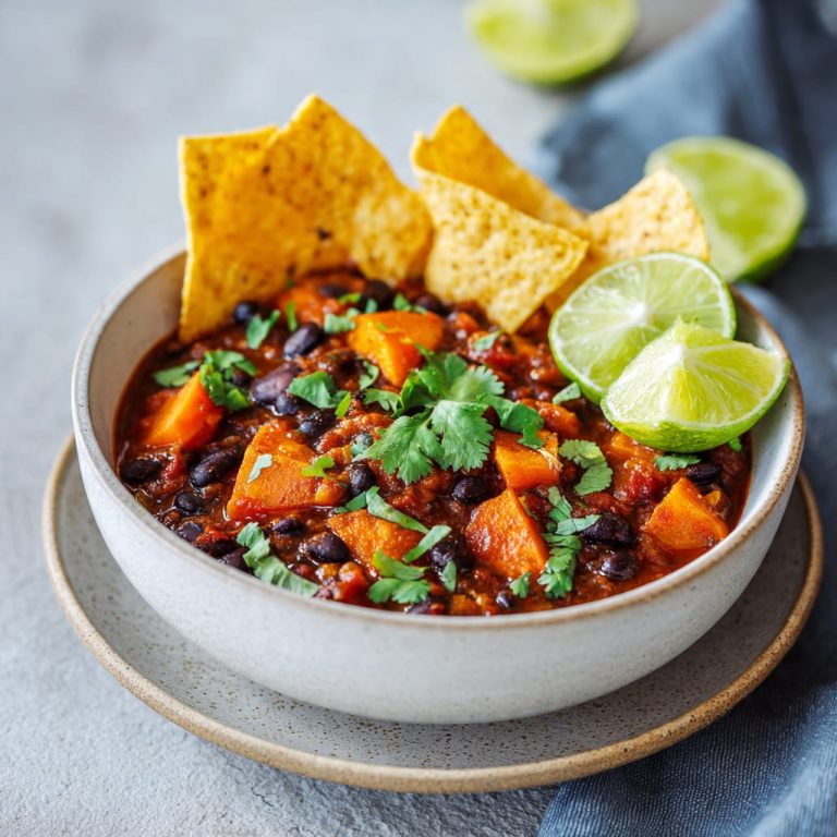 Close-up of vegan chili showing black beans and sweet potato pieces