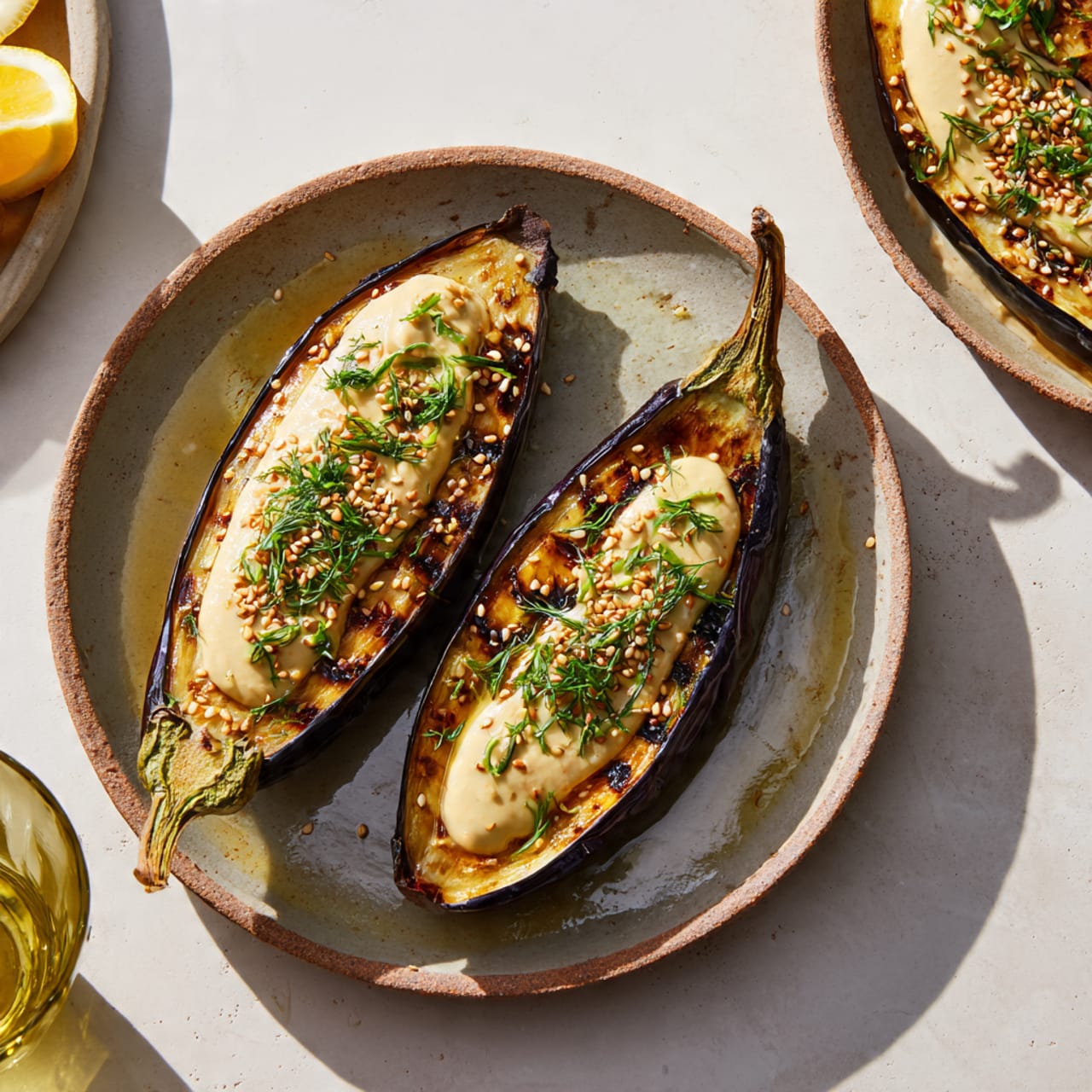 Roasted eggplant with lemon tahini sauce served in a modern home kitchen