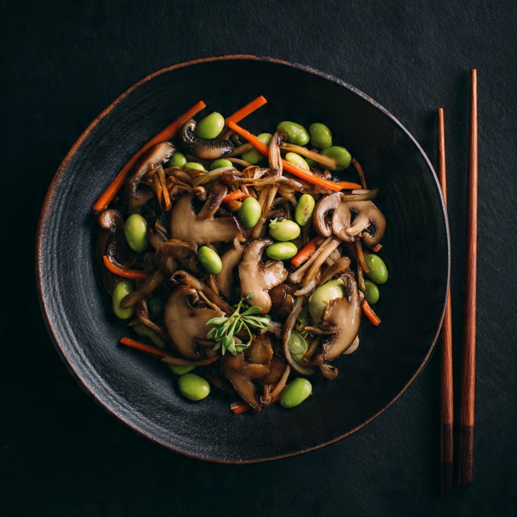 Japanese mushroom and edamame stir-fry photographed in minimalist flat lay style