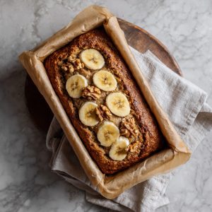 Artisanal preparation of banana oatmeal bread with oats, bananas, and walnuts before baking