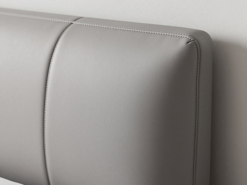 Detail of modern leather panel headboard edge stitching