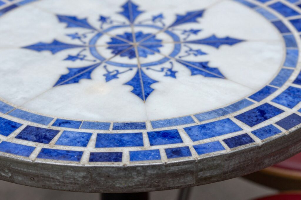 Detail of bistro table mosaic tile pattern and metal edge, NO PEOPLE, NO HUMANS, NO HANDS