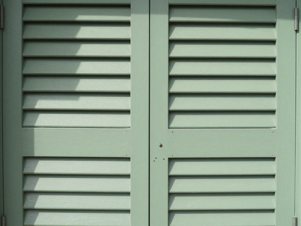 Sage green louvered kitchen cabinet doors